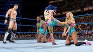 Carmella and Big E kicks continuingly by Asuka and Miz