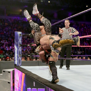 Kalisto puts Amore onto the ring apron