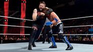 Styles putting Owens in a headlock