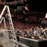 Ambrose and Rollins launch themselves off the ladders to take out Kane and Strowman