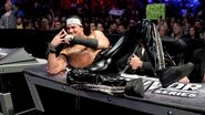 Drew McIntyre pose on the announce table