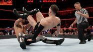 Rollins hit with a dropkick by Balor