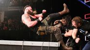 The Shield powerbomb Strowman through the announce table