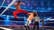 Nakamura jumps with a kicks into AJ Styles