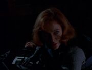 Dana Scully is surprised while tending to Fox Mulder