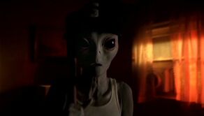 Grey alien with baseball paraphernalia