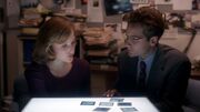 Fox Mulder shows Dana Scully fingerprints