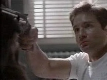 Fox Mulder being "pushed" to shoot and kill Dana Scully.