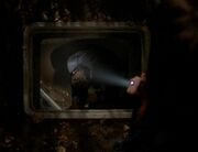 John Doggett descends into the sewers after the Bearded Man.