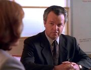 Fuller listens to Dana Scully