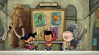 Xavier eating cereal outside the bulletin board.