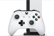 The Xbox One S controller pictured in front of the Console on it's vertical stand.