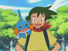 Pokemon trainer carrying his mudkip. his clothes are a black coat