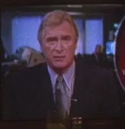 David Nichols as Newscaster #1