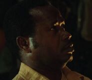 Martin Obuga as Muttering Man