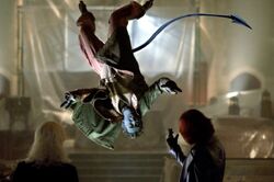 Jean Grey holding Nightcrawler in the air.