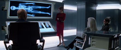 Jean explaining Logan's adamantium skeleton to Charles, Scott, and Ororo