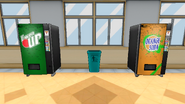 Two vending machines located in the cafeteria, with a trash can in the middle.