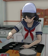 Ajia preparing some food in the Cooking Club.