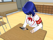 Aoi playing around on her phone before her classes start in-game.