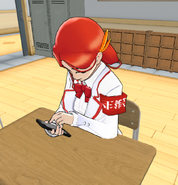 Akane playing around on her phone before her classes start in-game.