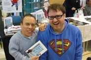 Simon wearing his iconic Superman hoodie with Warwick Davis.