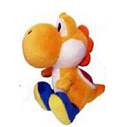 An Orange Yoshi plush.