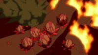 A flaming vine generates blossoms. Some at the back have already burst into clouds of  spores.