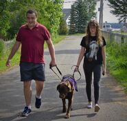 Gem and Jacob walking their dog, Wilson.