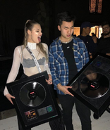 ricegum holding a speaker next to someone.