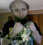 Cyraxx flexing an "18 karat gold" figure which is actually just a plastic figure spray-painted gold.