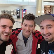 Mitch (center) and Jerome (right) running into PewDiePie (left) at an airport.