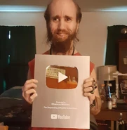 Cyraxx flexing a fake YouTube silver play button, which was mailed to him by CVG.