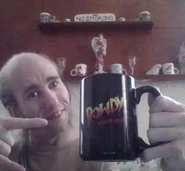 Cyraxx holding a mug.