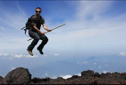A photoshop edit showing Gabe riding a stick and flying at the top of Mt. Fuji