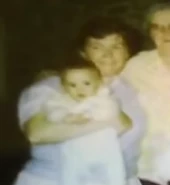 Cyraxx as a baby, being held by his grandmother Sally.