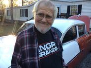 Angry Grandpa beside his dream car, a 55 Chevy Bel Air.