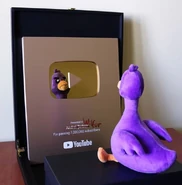 Wilfur next to Andrei's 1,000,000 subscriber plaque.