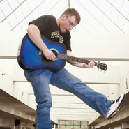 Mr. Beat playing a guitar