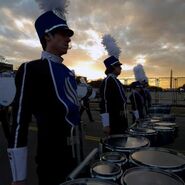 Cooper (leftmost) marching tenors in the GSU marching band