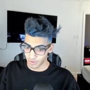 Skeppy with Blue Hair & Eyebrows, and wearing glasses.