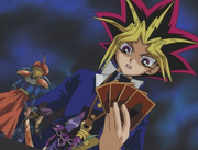 Yami Yugi dueling  in a  with Yugi and his friends as Yami's monsters on the field.