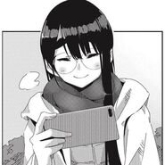 Minami looking at her phone in manga