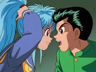 Yusuke hits Botan over the head.
