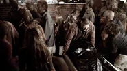 Murphy protecting Warren as the morgue gets overrun by zombies in the Nebraska Small Town