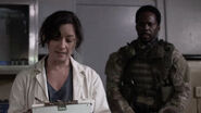 Dr. Merch informing the prisoners that they are receiving an experimental vaccine under orders of the president