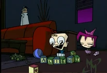 Baby  smiling prior to knocking over Baby ’s blocks.