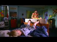 Dustin squirms around on the bed laughing.