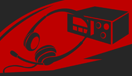 A headset resting on a desk in front of a radio receiver.