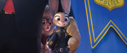 Judy, newly graduated from the academy, smiles for the cameras.